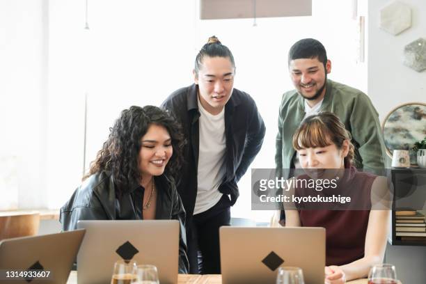 young entrepreneurs at coworking office in asia - global diversity stock pictures, royalty-free photos & images