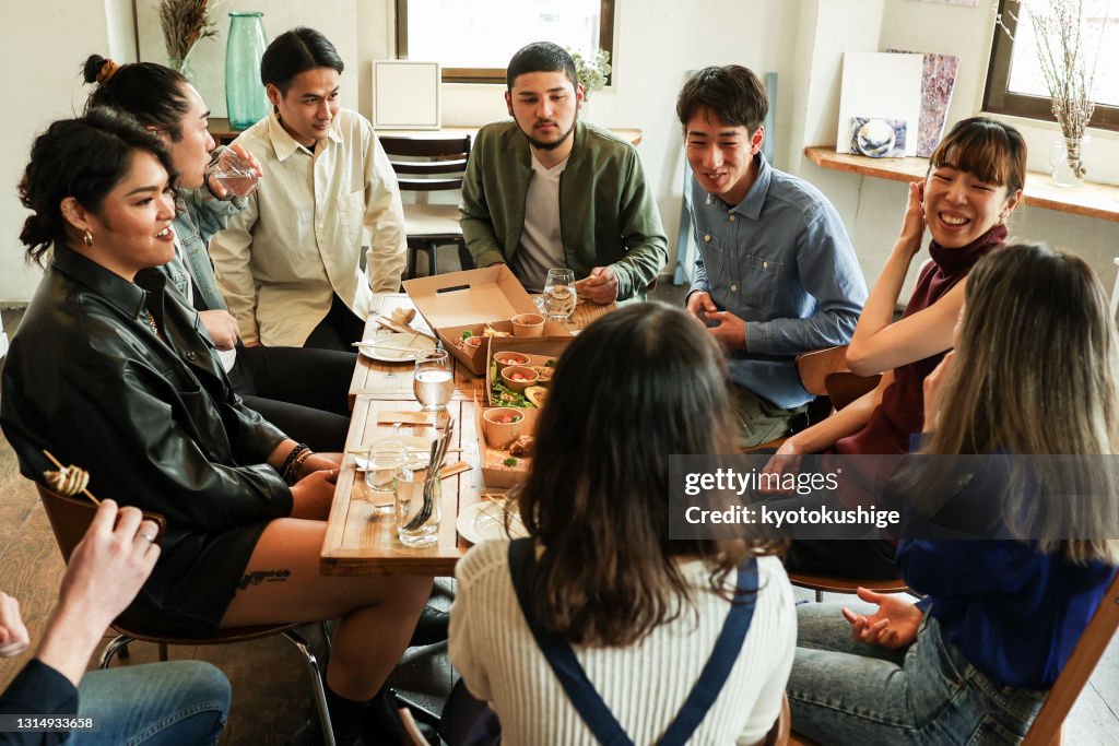 Friends having home party with vegan food