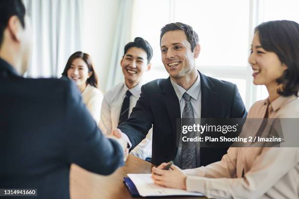 foreign businessman shaking hands - memorandum of understanding stock pictures, royalty-free photos & images