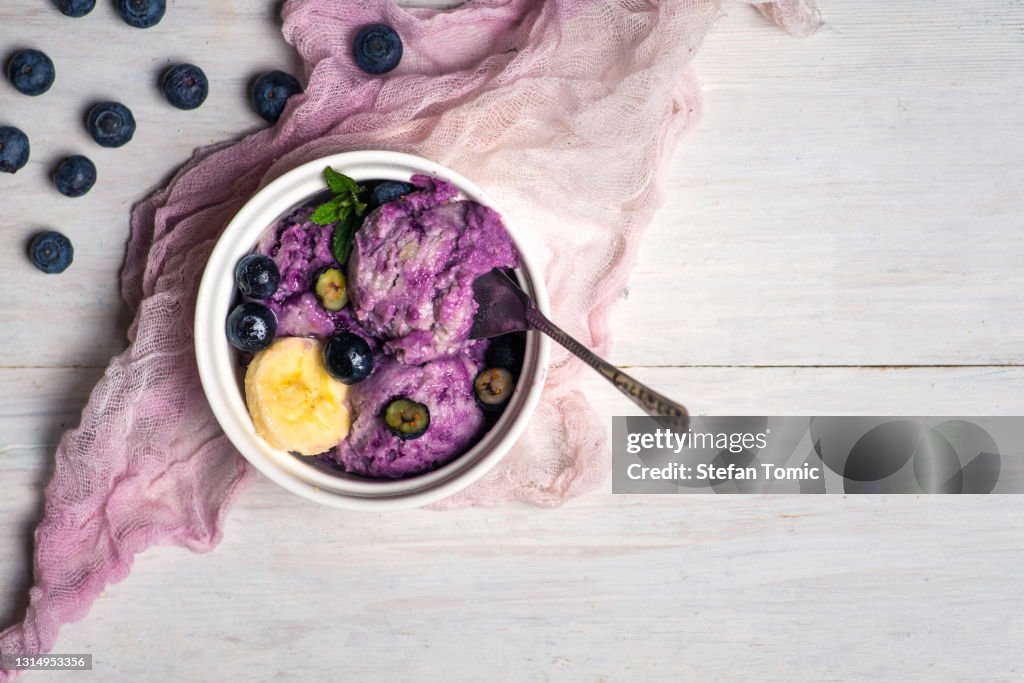 Homemade ice cream with blueberry berry fruit in a cup
