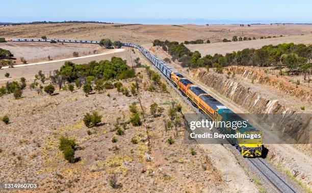 aerial view one rail australia loaded grain train passing through rolling hills - adelaide food stock pictures, royalty-free photos & images