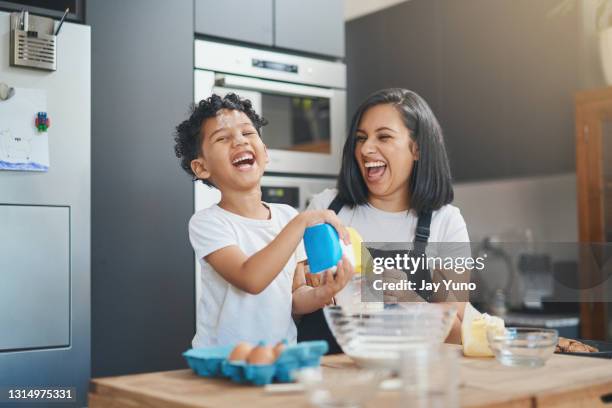 shot of a woman and her young son baking together at home - family small kitchen stock pictures, royalty-free photos & images