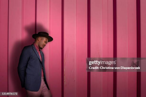 young fashionable african man at metallic wall - catwalk background stock pictures, royalty-free photos & images