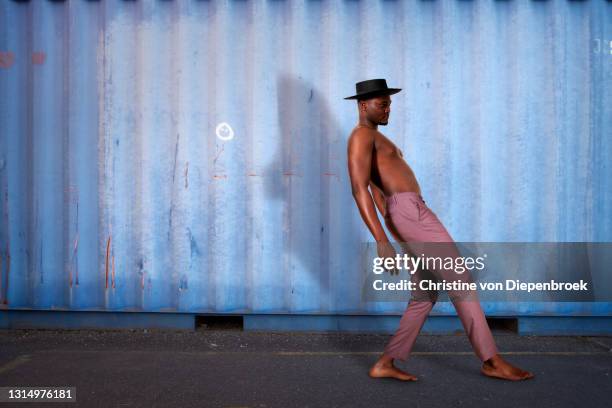 young fashionable african man at metallic wall - catwalk background stock pictures, royalty-free photos & images