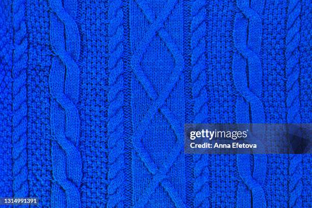 texture of smooth knitted blue sweater with pattern. flat lay style, close-up. - 編む ストックフォトと画像