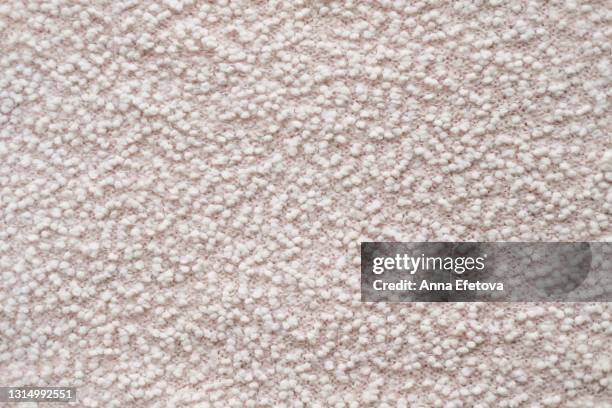 texture of a pastel pink fabric with white soft pellets. flat lay style, close-up. - granule stockfoto's en -beelden