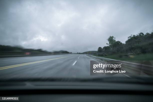 a view of the freeway on a rainy day from the car - dashboard camera point of view stock pictures, royalty-free photos & images