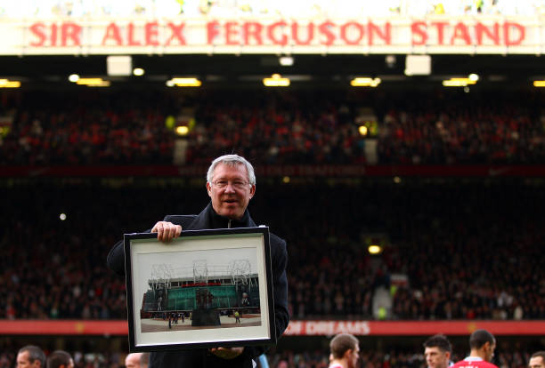 Sir Alex Ferguson is presented with a photo to commemerate his 25th year as manager, as the North Stand is renamed the 'Sir Alex Ferguson Stand'...
