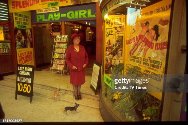 Actress Irene Handl standing in front of a pornographic cinema with her dogs in London's Soho, circa 1970.