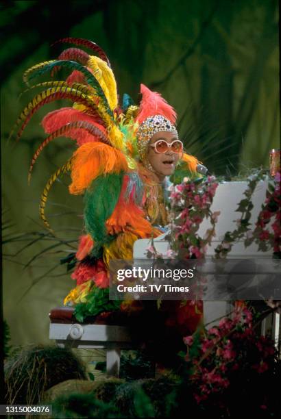 English pop/rock musician Elton John performing his song 'Crocodile Rock' on the set of The Muppet Show at Elstree Studios, Hertfordshire, circa...