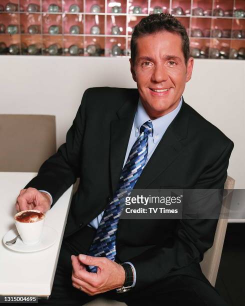 Television presenter Dale Winton photographed in a cafe, circa 2003.