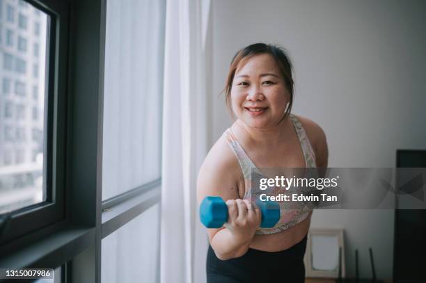 asian chinese body -positive woman workout at home during weekend - fat asian woman stock pictures, royalty-free photos & images