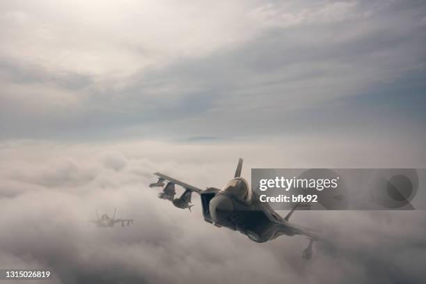 jet aircrafts flying over the clouds. - air force stock pictures, royalty-free photos & images