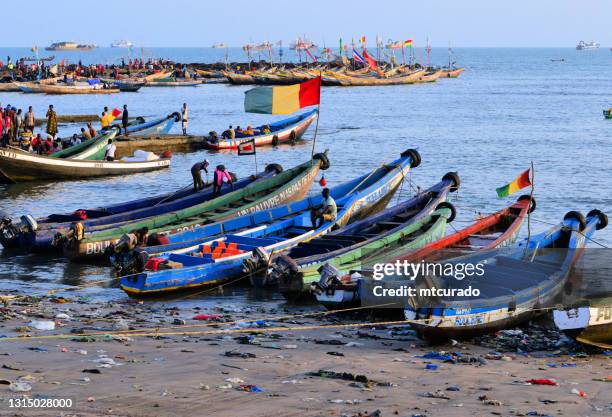 boulbinet artisanal fishing port - pirogues and guinean flag, conakry, guinea - guinea flag stock pictures, royalty-free photos & images