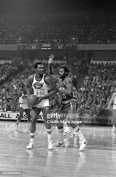 Denver Nuggets guard Ted McClain is checked by Golden State Warriors guard Charles Johnson during an NBA basketball game at McNichols Arena on...