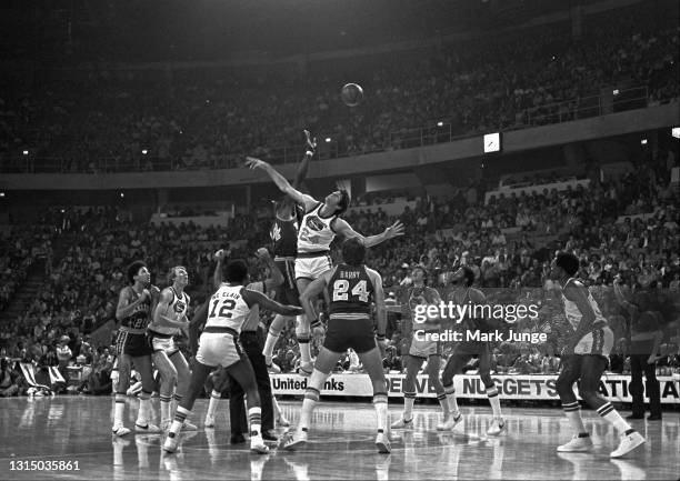 Golden State Warriors center Clifford Ray competes for a tipoff against Denver Nuggets forward Bobby Jones during an NBA basketball game at McNichols...