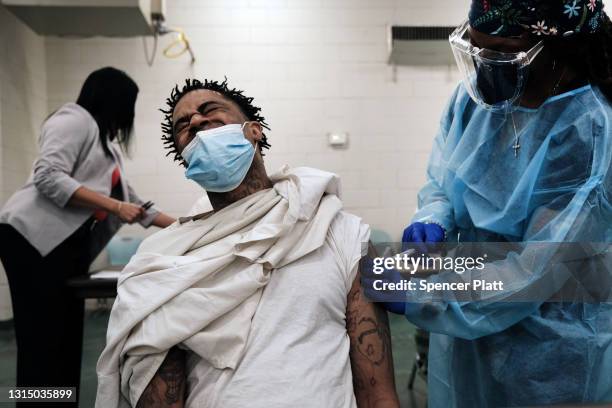 Prisoner at the Bolivar County Correctional Facility reacts as he receives a Covid-19 vaccination administered by medical workers with Delta Health...