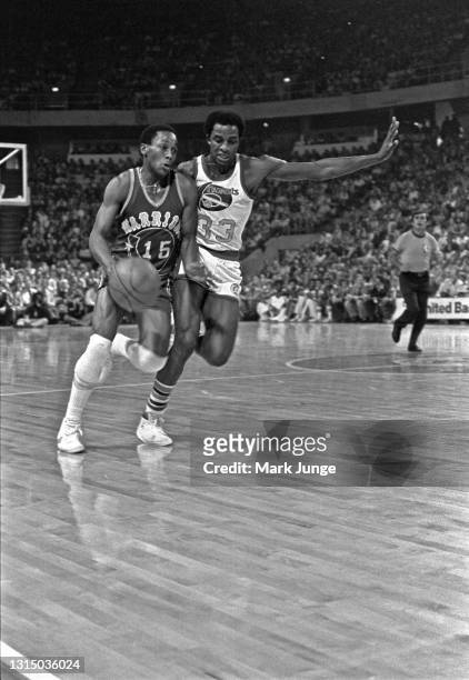 Golden State Warriors guard Charles Dudley drives past Denver Nuggets forward David Thompson during an NBA basketball game at McNichols Arena on...