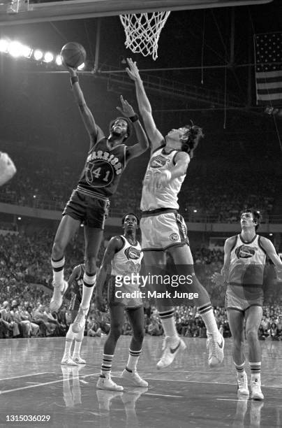 Golden State Warriors forward Jamaal Wilkes drives for a layup against Denver Nuggets forward Gus Gerard during an NBA basketball game at McNichols...