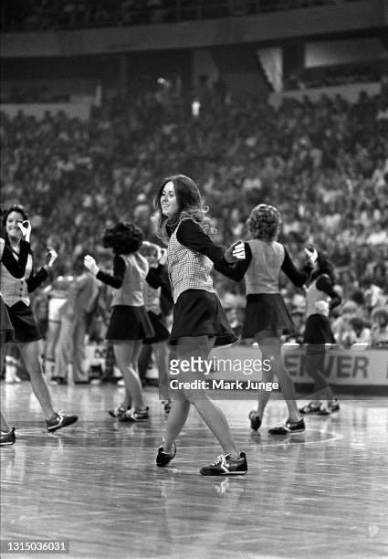 Denver Nuggets cheerleaders perform a dance routine on the court during a timeout in an NBA basketball game against the Golden State Warriors at...
