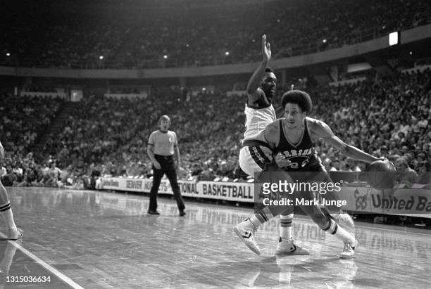 Golden State Warriors guard Phill Smith drives past Denver Nuggets guard Ted McClain during an NBA basketball game at McNichols Arena on November 9,...