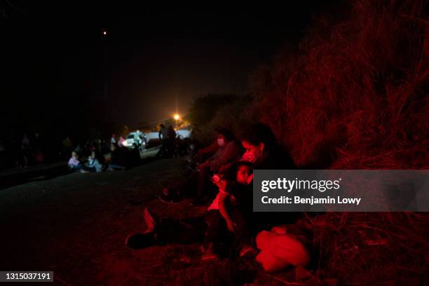 Migrant woman breast feeds an infant while waiting to be proceed by Border Patrol officers on April 24, 2021 in Roma, Texas. Guided by coyotes...