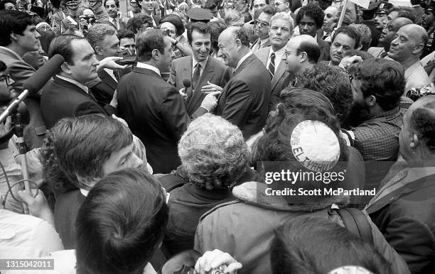 High-angle view of American politicians Governor Mario Cuomo and Mayor Ed Koch as they talk together, surrounded by journalists, during the Columbus...