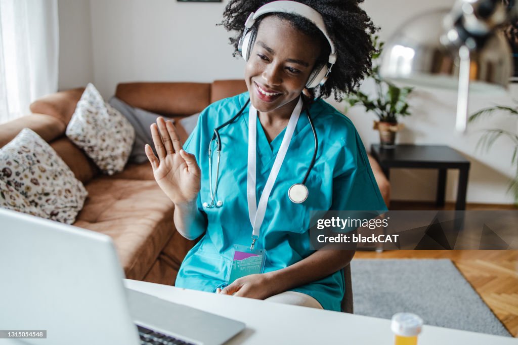 Female doctor is communication online with the patient via video call