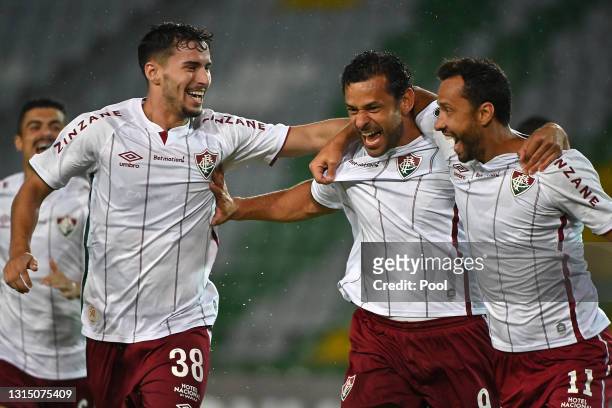 Fred of Fluminense celebrates with teamamte Matheus Martinelli and Nene after scoring the first goal of his team during a match between Independiente...