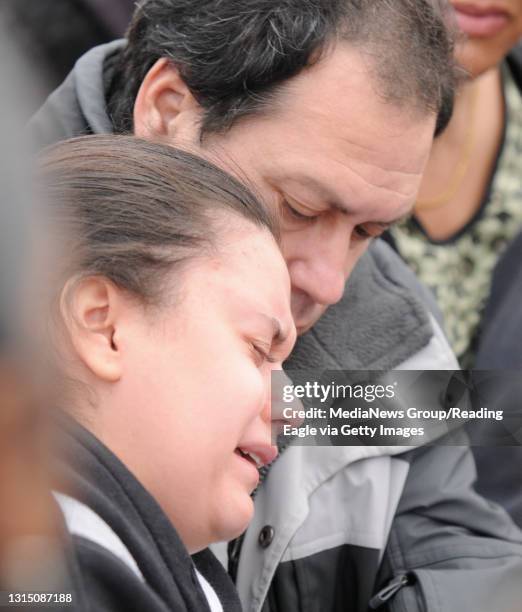 David's father Miguel, right, supports his daughter Diana Arango as she begins to weep. Community and family members gather along Scott. St. And the...