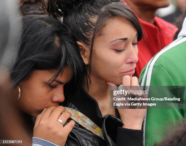 Jasmine Santos, a Reading High freshman supports, Alicia Rosado, right, a senior, who cries for her friend whom she had known since first grade....