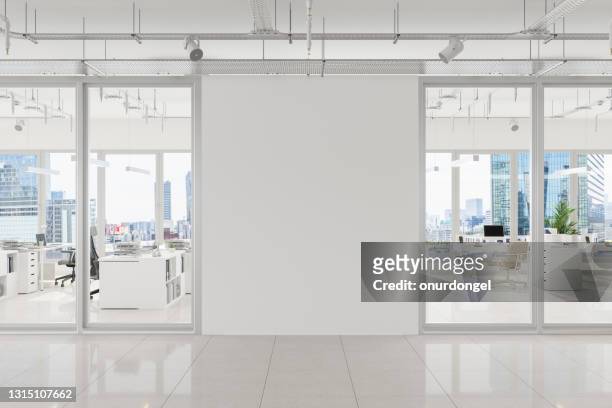 modern open plan office with white blank wall and cityscape background - simplicity stock pictures, royalty-free photos & images