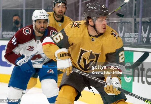 Mattias Janmark of the Vegas Golden Knights eyes the puck as he skates ahead of Pierre-Edouard Bellemare of the Colorado Avalanche in the second...