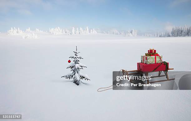 a sled with christmas gifts and christmas tree - pile of gifts stock pictures, royalty-free photos & images