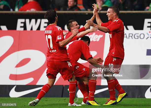 Lukas Podolski of Koeln celebrates with his team mates after scoring his team's second goal during the Bundesliga match between Werder Bremen and 1....