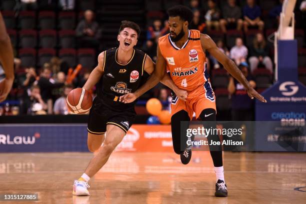 Francis Mulvihill of Taranaki runs the ball up court whilst under pressure from Alonzo Burton of the Southland Sharks of the during the round one NBL...