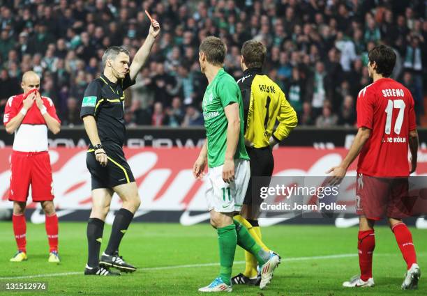 Henrique Sereno of Koeln gets the red card from referee Michael Weiner during the Bundesliga match between Werder Bremen and 1. FC Koeln at Weser...