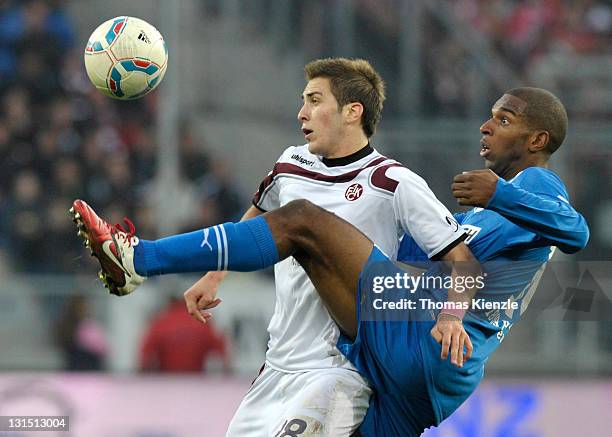 Ryan Babel of Hoffenheim and Konstantinos Fortounis of Kaiserslautern vie for the ball during the Bundesliga match between 1899 Hoffenheim and 1. FC...