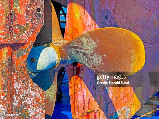 brass ship's propeller and rudder close-up. - ship propeller stock pictures, royalty-free photos & images