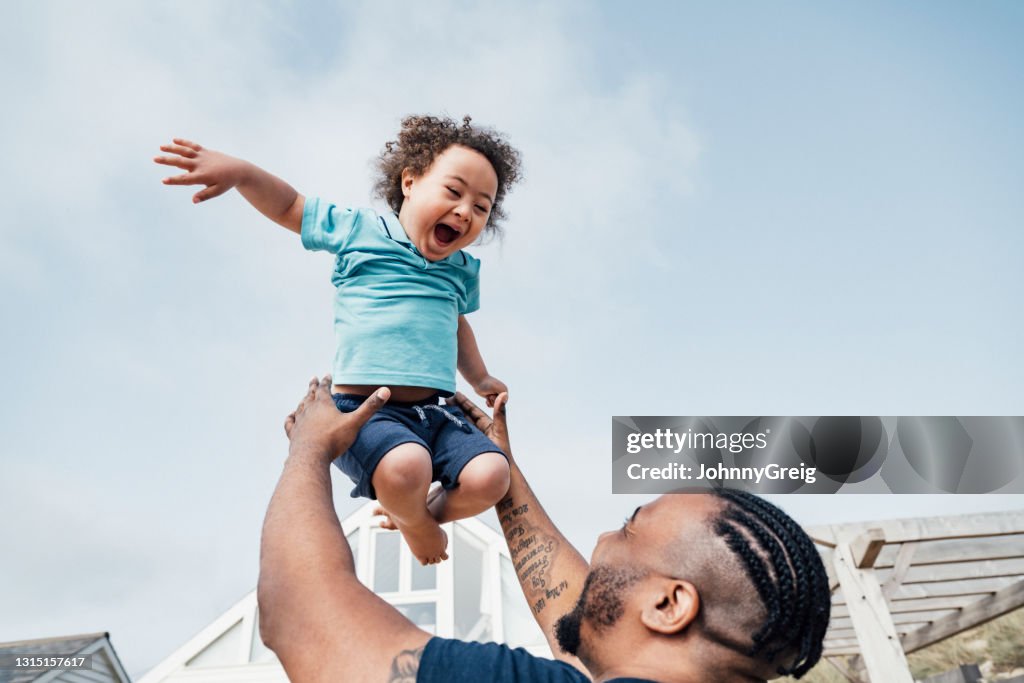 Young boy with Down Syndrome expressing joy in mid-air