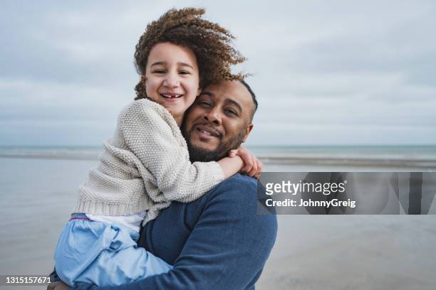 portrait of british father and daughter at camber sands - real people family stock pictures, royalty-free photos & images