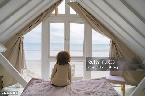 young british girl looking at view from vacation beach house - beach holiday uk stock pictures, royalty-free photos & images