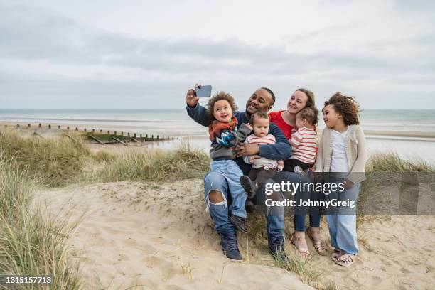 vacationing british family posing for selfie at camber sands - family selfie stock pictures, royalty-free photos & images