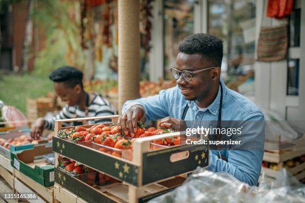 two african american colleagues working in the fruit and vegetable store - support local stock pictures, royalty-free photos & images