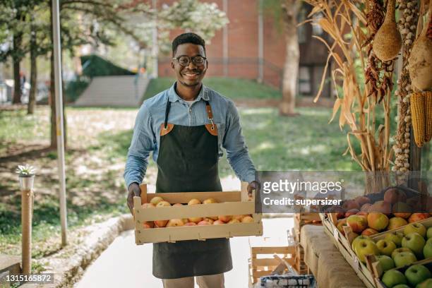 young man working in the grocery store - support local stock pictures, royalty-free photos & images