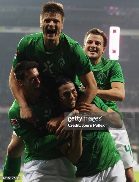 Claudio Pizarro of Bremen celebrates with his team mates after scoring his team's third goal during the Bundesliga match between Werder Bremen and 1....