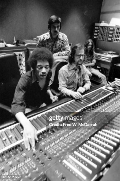 American musician Jimi Hendrix , South African-born American music producer and engineer Eddie Kramer and studio manager Jim Marron make adjustments...