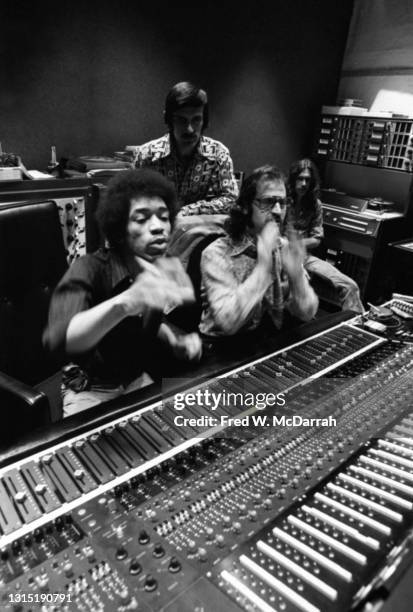 American musician Jimi Hendrix , South African-born American music producer and engineer Eddie Kramer and studio manager Jim Marron make adjustments...