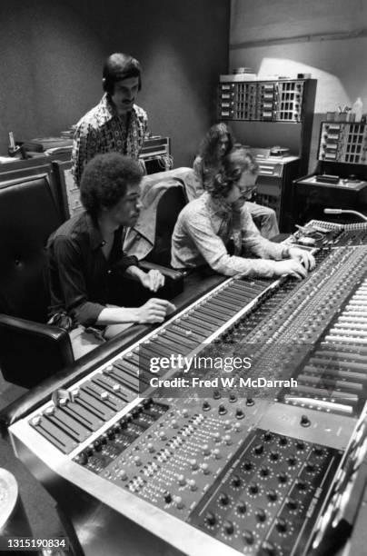 American musician Jimi Hendrix , South African-born American music producer and engineer Eddie Kramer and studio manager Jim Marron make adjustments...