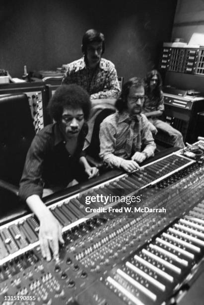 American musician Jimi Hendrix , South African-born American music producer and engineer Eddie Kramer and studio manager Jim Marron make adjustments...